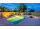 Night view of a private pool with a waterfall feature and soft landscaping lighting, creating a serene atmosphere at 490 W Encinas St, Gilbert, AZ 85233