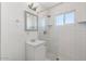 Bathroom featuring subway tile walls, hexagon tile floor, window, and vanity with storage at 5011 S 20Th Pl, Phoenix, AZ 85040