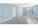 Bright bedroom with blue walls, wood-look tile floor, and natural light from the window at 5011 S 20Th Pl, Phoenix, AZ 85040