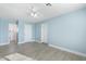 Spacious bedroom featuring light blue walls, tile floors, and a ceiling fan for added comfort at 5011 S 20Th Pl, Phoenix, AZ 85040