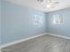 Bedroom featuring light blue walls, tile floors, ceiling fan and windows for natural light at 5011 S 20Th Pl, Phoenix, AZ 85040