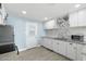 Well-lit kitchen featuring granite countertops, white cabinets, and updated appliances for a modern feel at 5011 S 20Th Pl, Phoenix, AZ 85040