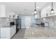 Modern kitchen featuring white cabinets, granite countertops, and stainless steel appliances at 5011 S 20Th Pl, Phoenix, AZ 85040