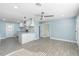Open-concept living room flowing into the kitchen featuring an island and recessed lighting at 5011 S 20Th Pl, Phoenix, AZ 85040