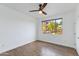 Cozy bedroom with wood-look flooring, a ceiling fan, and bright natural light through the window at 5401 E Van Buren St # 1004, Phoenix, AZ 85008