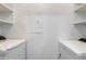 Laundry area with full-size washer and dryer units with storage shelves at 5401 E Van Buren St # 1004, Phoenix, AZ 85008