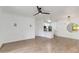 Bright living room featuring hardwood floors, a ceiling fan, and an open layout to the kitchen at 5401 E Van Buren St # 1004, Phoenix, AZ 85008
