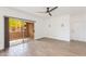 Bright, airy living room featuring a ceiling fan, a sliding glass door and tile flooring at 5401 E Van Buren St # 1004, Phoenix, AZ 85008