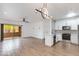 Open-concept living space with modern lighting, sliding glass door, and adjacent kitchen at 5401 E Van Buren St # 1004, Phoenix, AZ 85008