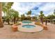 Community pool and spa surrounded by palm trees and lounge chairs for relaxation at 5401 E Van Buren St # 1004, Phoenix, AZ 85008