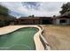 A backyard featuring a pool and a large, dry grass area, perfect for recreation and relaxation at 5542 W Monte Cristo Ave, Glendale, AZ 85306