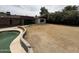 A backyard featuring a pool and a large, dry grass area, perfect for recreation and relaxation at 5542 W Monte Cristo Ave, Glendale, AZ 85306