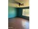 Sunny bedroom featuring hardwood floors, a ceiling fan, and a window offering ample natural light at 5542 W Monte Cristo Ave, Glendale, AZ 85306