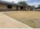 Charming single-story home featuring stone accents, desert landscaping, and modern solar panels at 5542 W Monte Cristo Ave, Glendale, AZ 85306