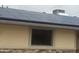 Close-up of solar panels on the roof, with a window and stone accents along the side of the home at 5542 W Monte Cristo Ave, Glendale, AZ 85306