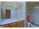 Bright bathroom featuring a vanity, toilet, and a shower with a glass enclosure at 629 E State Ave, Phoenix, AZ 85020