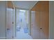 Hallway leading to a well-lit bathroom with a toilet and vanity at 629 E State Ave, Phoenix, AZ 85020