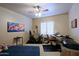 Multi-purpose room featuring a daybed, desk, exercise equipment, and ample natural light at 629 E State Ave, Phoenix, AZ 85020