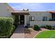 View of front entrance with well manicured shrubs and a red tiled roof at 629 E State Ave, Phoenix, AZ 85020