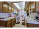 Kitchen features white tile counters, oak cabinets and a skylight at 629 E State Ave, Phoenix, AZ 85020