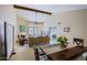 Spacious living room featuring vaulted ceilings, fireplace, and access to back patio at 629 E State Ave, Phoenix, AZ 85020