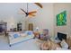 Inviting living room with cozy seating, fireplace, and ceiling fan at 629 E State Ave, Phoenix, AZ 85020