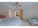 Bright bedroom with large bed, seating area and ceiling fan at 629 E State Ave, Phoenix, AZ 85020