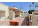 Private brick patio with comfortable seating, decorative elements, and palm tree views at 629 E State Ave, Phoenix, AZ 85020