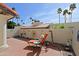 Relaxing outdoor patio space featuring decorative art and a lounge chair on a red brick surface at 629 E State Ave, Phoenix, AZ 85020