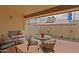 Cozy patio area featuring brick flooring, comfortable seating, and decorative art on the surrounding walls at 629 E State Ave, Phoenix, AZ 85020