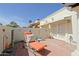 Charming patio with brick flooring, decorative elements, and access to the home through elegant French doors at 629 E State Ave, Phoenix, AZ 85020