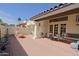 Quaint patio with brick flooring, complemented by cozy seating arrangements and access through French doors at 629 E State Ave, Phoenix, AZ 85020