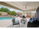 Inviting covered patio area with comfortable seating, fan, overlooking pool and spa at 6439 W Kristal Way, Glendale, AZ 85308