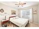 Inviting bedroom with a ceiling fan and a large window for natural light at 6439 W Kristal Way, Glendale, AZ 85308