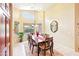 Cozy dining room with natural light, table for eight, and view of the landscaped backyard at 6439 W Kristal Way, Glendale, AZ 85308