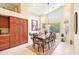 Elegant dining room with a large window, high ceilings, and a dining table for eight at 6439 W Kristal Way, Glendale, AZ 85308