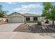 Charming single-story home with a well-maintained front yard and a two-car garage at 6439 W Kristal Way, Glendale, AZ 85308