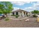 Inviting single-story home with manicured landscaping, desert rock, and a charming front porch at 6439 W Kristal Way, Glendale, AZ 85308