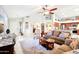Bright and airy living room with comfortable seating, tile flooring, and a view to the kitchen at 6439 W Kristal Way, Glendale, AZ 85308