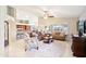 Open-concept living room with a ceiling fan, tile floors, and abundant natural light at 6439 W Kristal Way, Glendale, AZ 85308