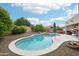 Sparkling private pool with rock waterfall feature surrounded by lush landscaping at 6439 W Kristal Way, Glendale, AZ 85308