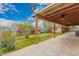Spacious backyard featuring a covered patio, lush greenery, and a well-maintained yard at 6837 W Camelback Rd, Phoenix, AZ 85033