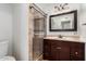 Bathroom featuring a glass-enclosed shower and vanity with marble countertops at 6837 W Camelback Rd, Phoenix, AZ 85033