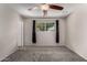 Bright bedroom featuring neutral walls, carpet floors, ceiling fan, and a window with outside views at 6837 W Camelback Rd, Phoenix, AZ 85033