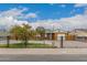 Charming single-story home with a large, fenced front yard and a sunny, blue sky backdrop at 6837 W Camelback Rd, Phoenix, AZ 85033