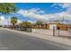 Charming home featuring a well-manicured lawn and convenient gated driveway at 6837 W Camelback Rd, Phoenix, AZ 85033