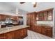 Spacious kitchen with stainless steel appliances, dark wood cabinets, and granite countertops at 6837 W Camelback Rd, Phoenix, AZ 85033