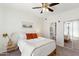 Cozy bedroom with ceiling fan, neutral tones, and ensuite bathroom and mirrored closet at 6900 E Princess Dr # 2247, Phoenix, AZ 85054