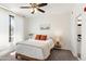 Comfortable bedroom featuring a ceiling fan, natural light, and neutral decor at 6900 E Princess Dr # 2247, Phoenix, AZ 85054