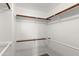Walk-in closet with wood shelving and rods, offering ample storage space at 6900 E Princess Dr # 2247, Phoenix, AZ 85054